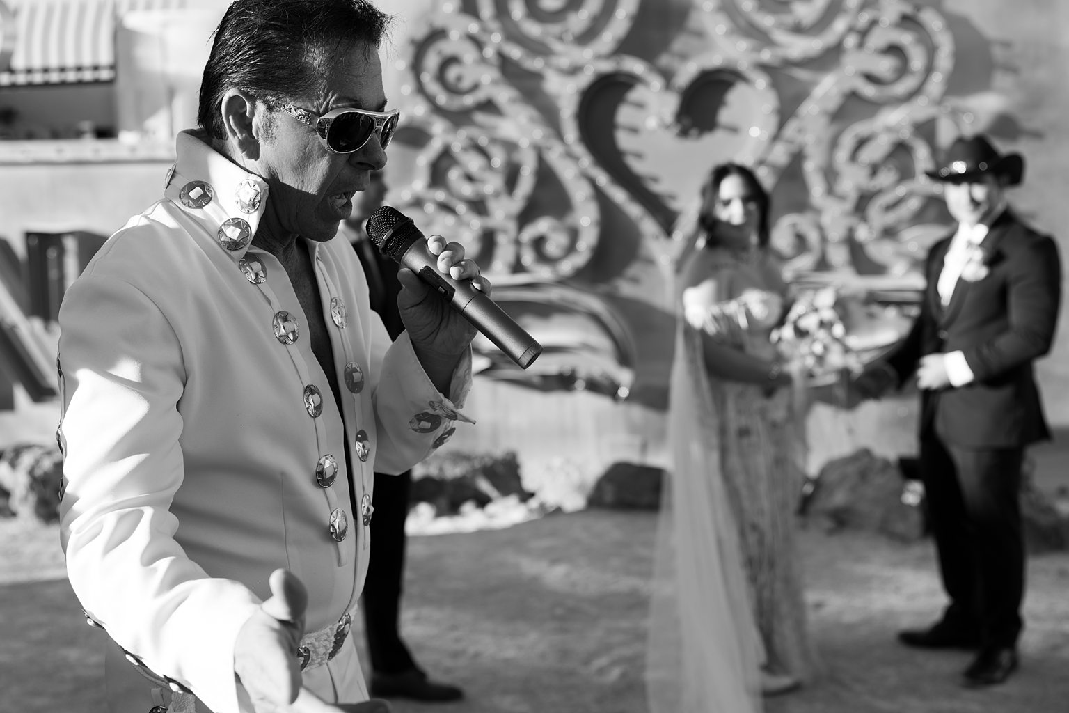 Black and white photo of a couple at the altar during their Elvis wedding ceremony at Neon Museum in Las Vegas