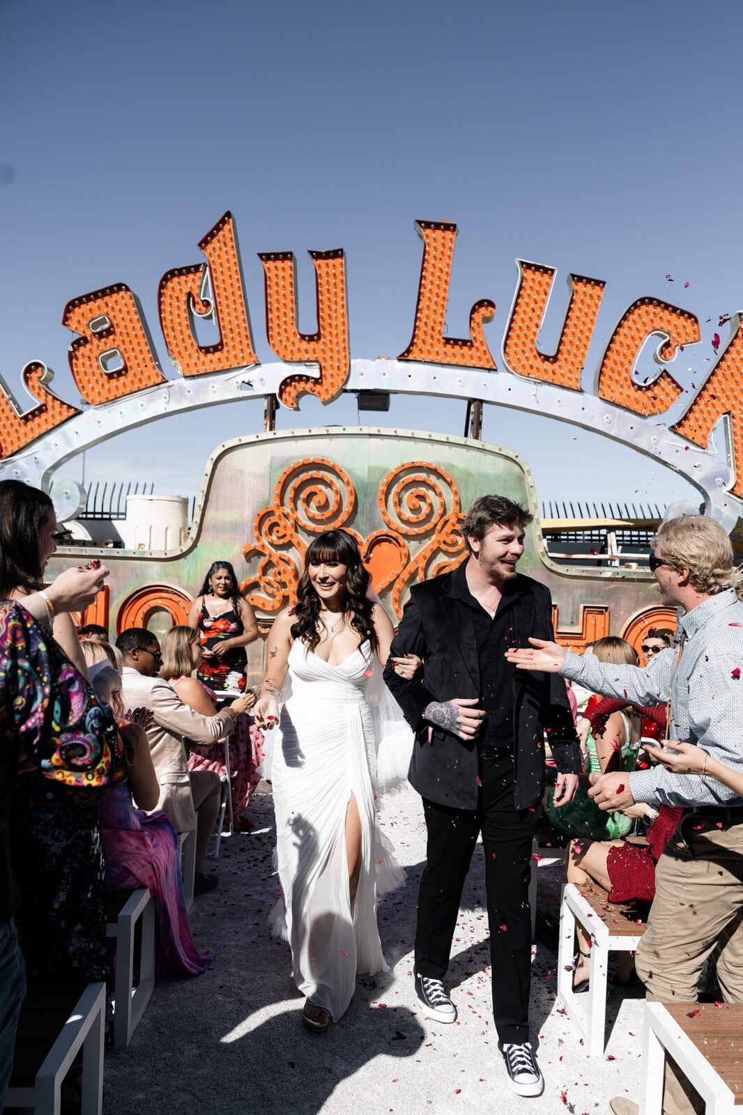 Bride and groom walking down the aisle after their Neon Museum wedding ceremony