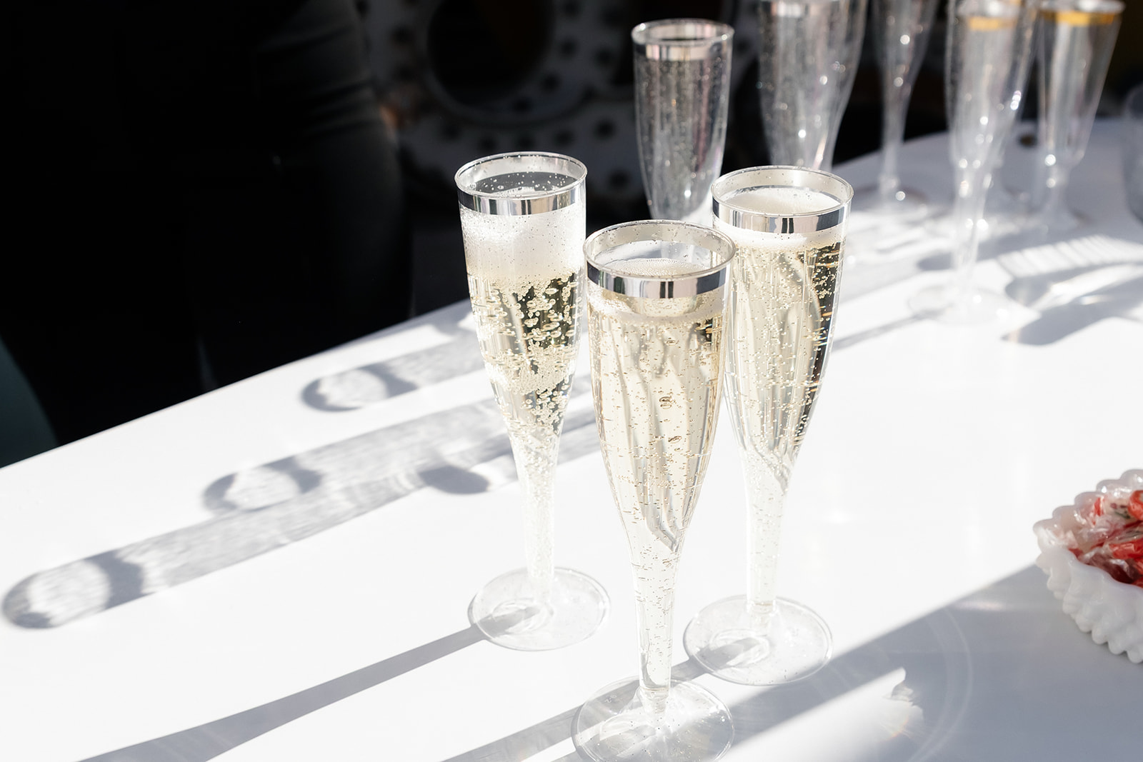 Glasses of champagne sitting on a table.