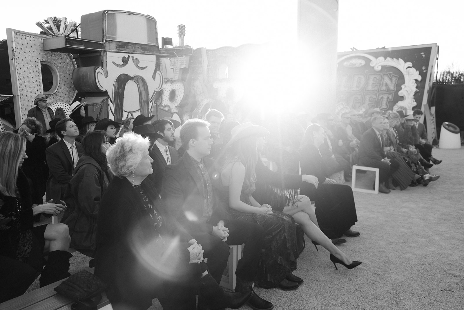 Black and white photo of guests waiting for a Neon Museum wedding ceremony to begin. 