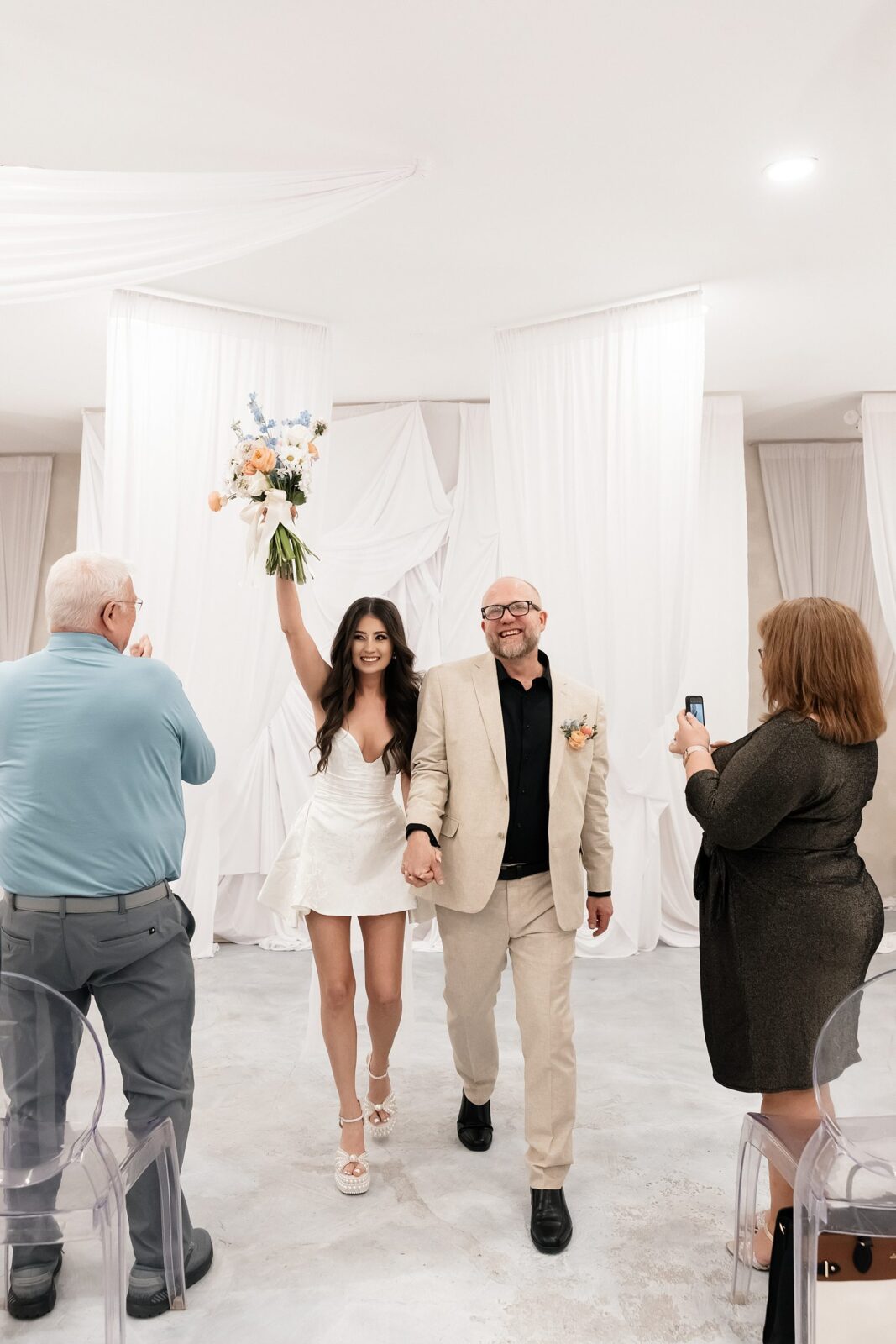 Bride and groom walking back down the aisle after their That Chapel Downtown wedding ceremony