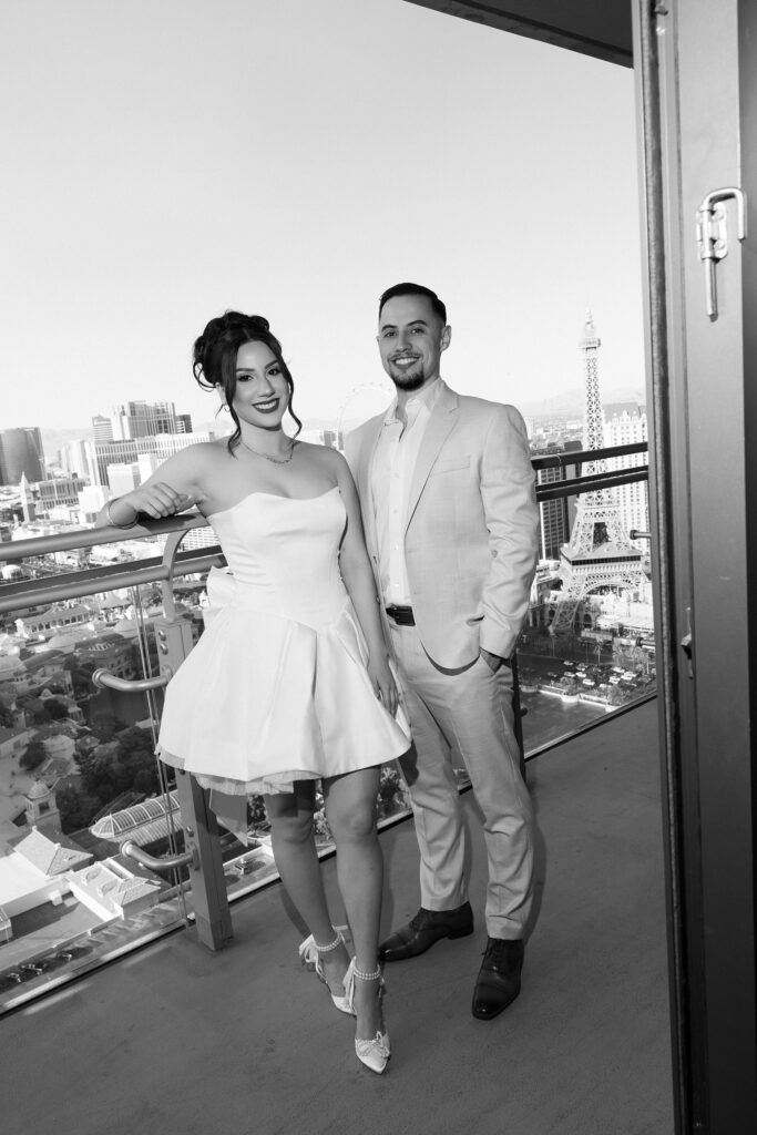 Bride and groom posing on the Cosmos terrace balcony suite