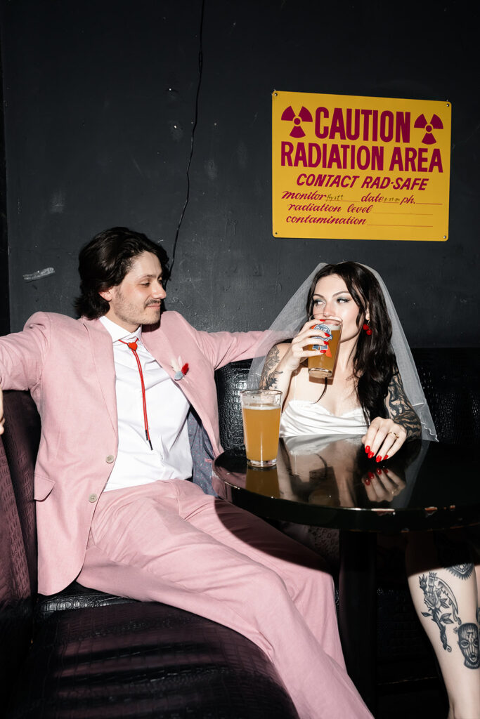 Couple having post-elopement drinks at Atomic Liquors 