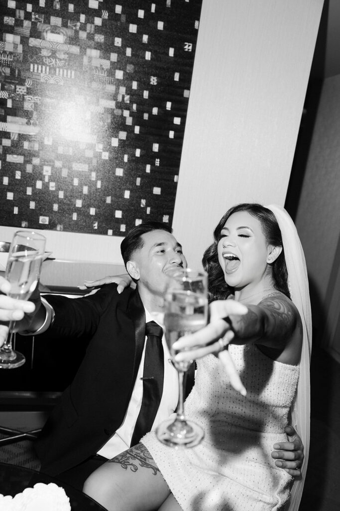 Bride and groom toasting champagne in the Cosmopolitan Terrace Suite