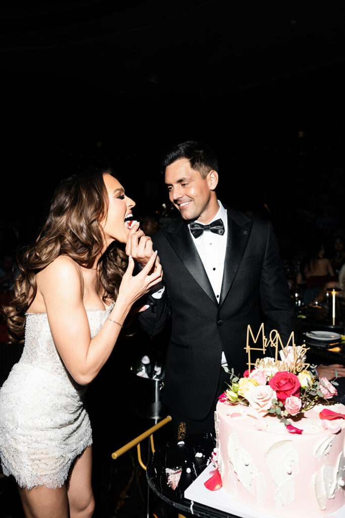 Groom feeding the bride cake during their Las Vegas wedding reception at Papi Steak