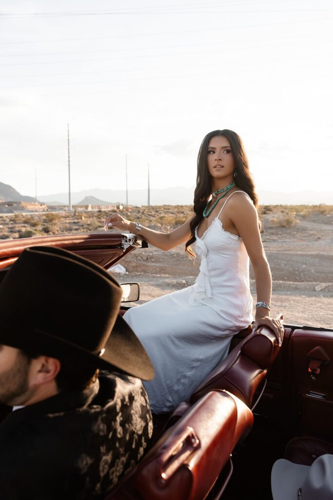 Engaged couple sitting in a convertible for their desert western engagement photos in Las Vegas near Lee Canyon