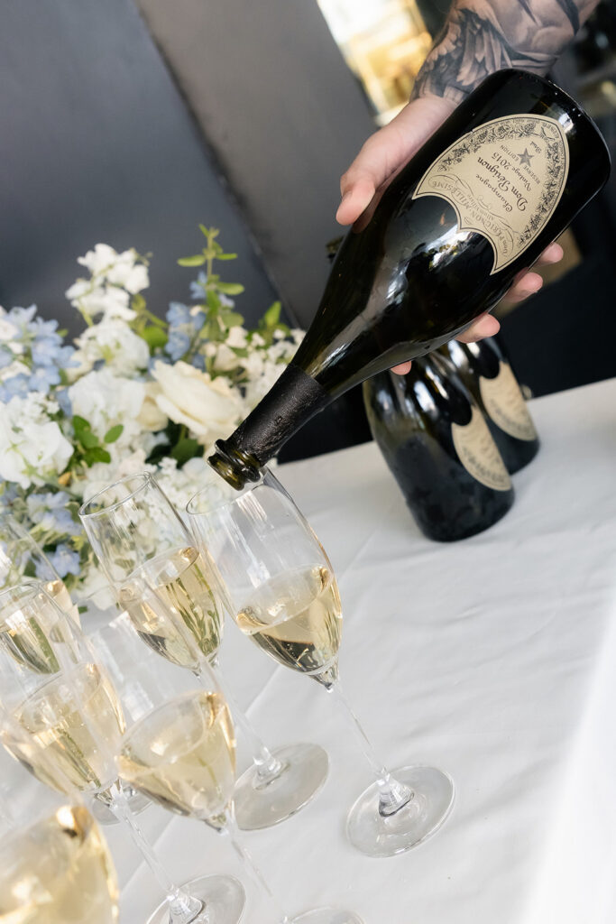 Champagne being poured during Spago Las Vegas elopement reception.
