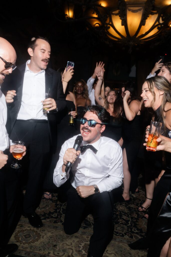 Groom singing with guests on the dance floor at Doberman Drawing Room in Las Vegas.
