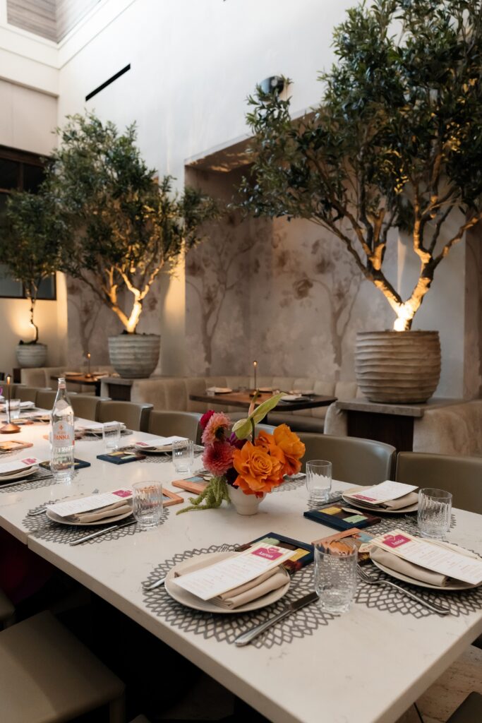 Wedding dinner plates and colorful florals on a reception table at The Guest House Las Vegas.