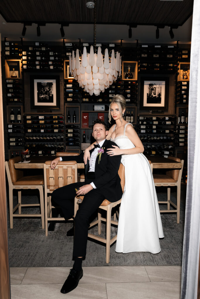 Bride and groom posing in the wine room at The Guest House Las Vegas.