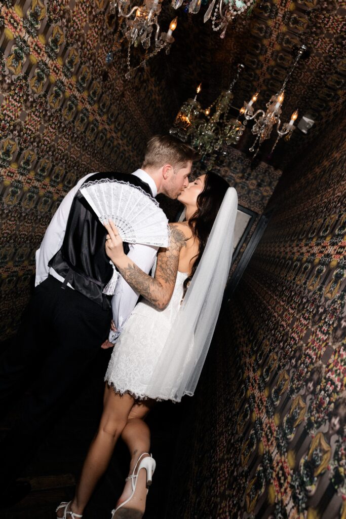 Bride and groom kissing in a hallway during their Las Vegas micro wedding reception at The Park on Fremont.