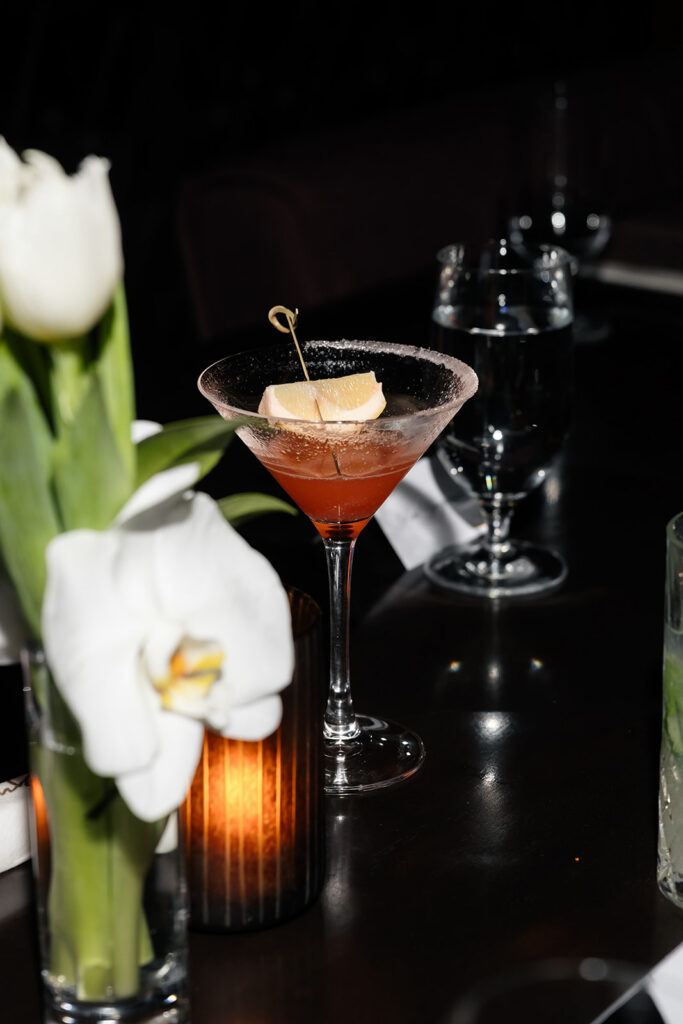 Cocktail and white tulips at La Cave Wine and Food Hideaway.