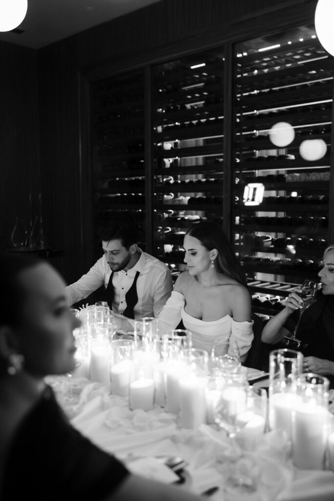 Bride and groom eating dinner with their family at Barry's prime for their intimate Las Vegas micro wedding reception dinner.