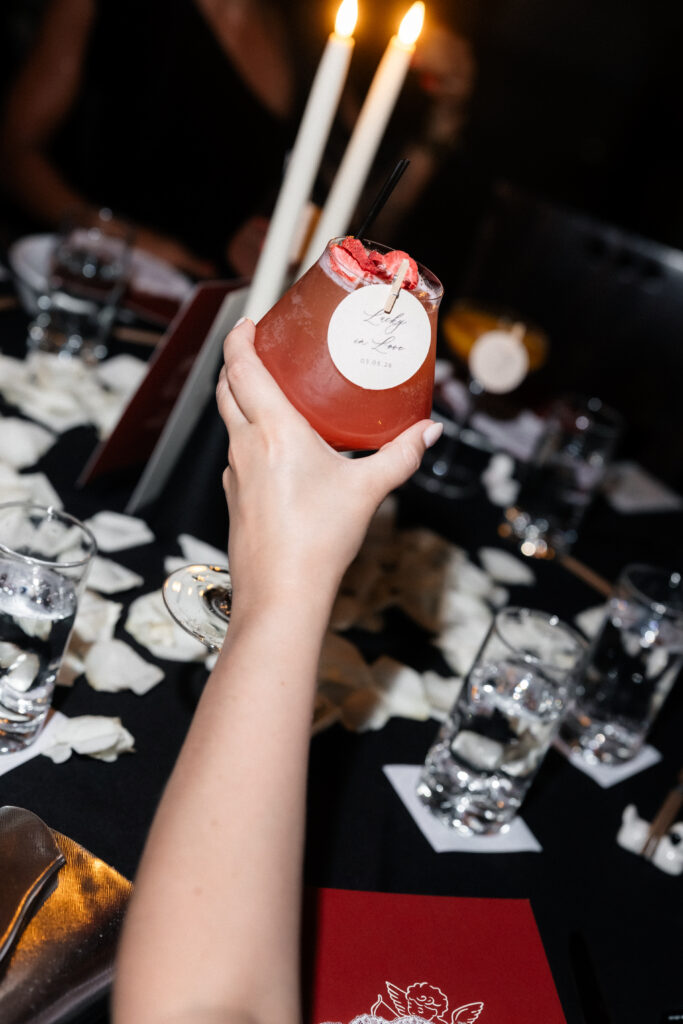 Guest holding up a drink at Asian Bistro in Las Vegas.