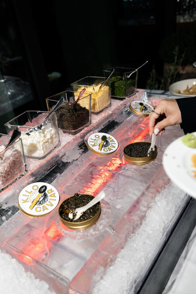Guest scooping caviar onto their plate during a las Vegas wedding reception at Ocean Prime.