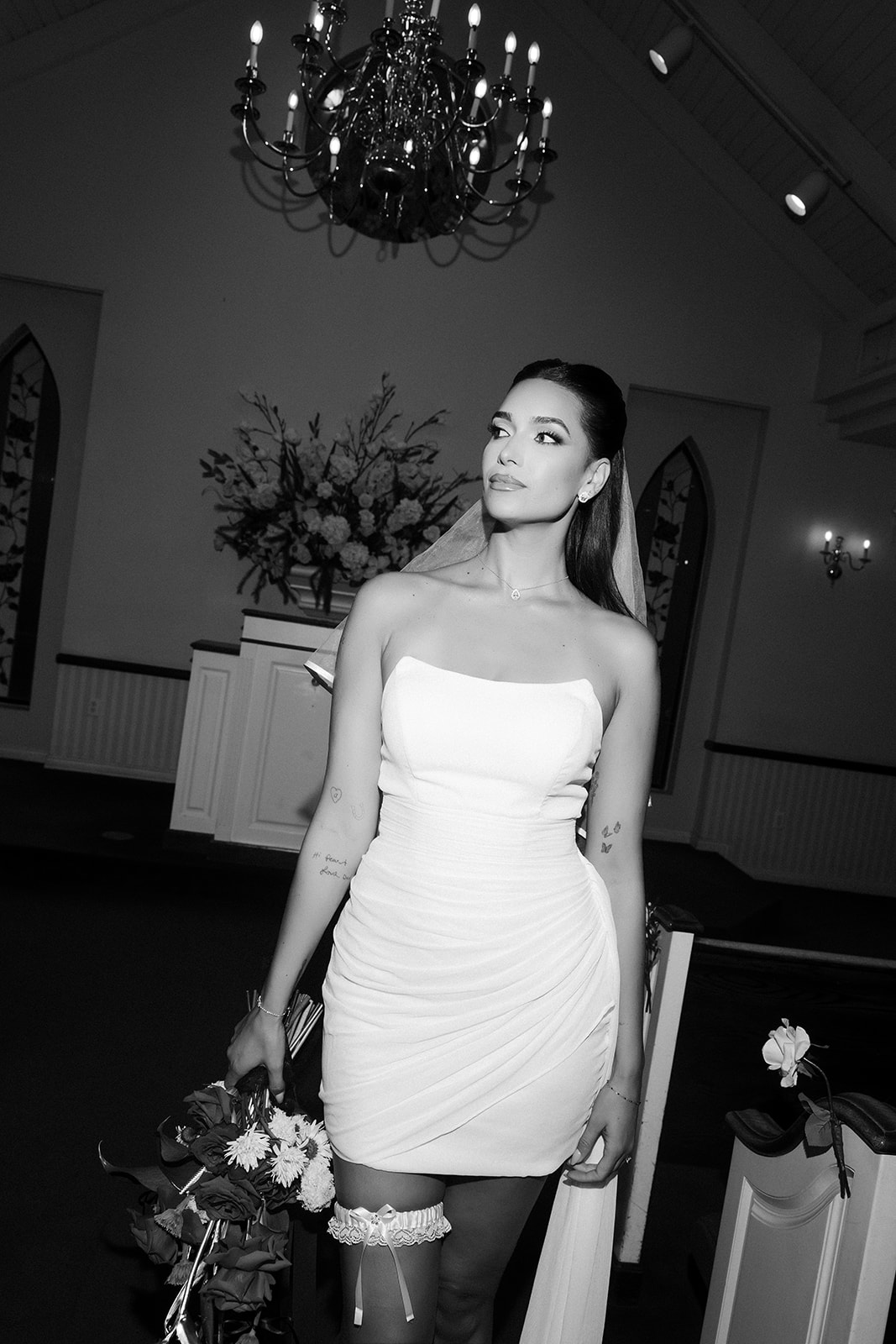 Black and white photo of April Love Geary posing for her Vegas elopement photos at A Special Memory Wedding Chapel