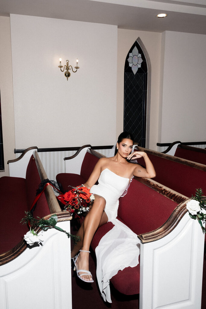 Bride posing in the church pews at A Special Memory Wedding Chapel in Las Vegas