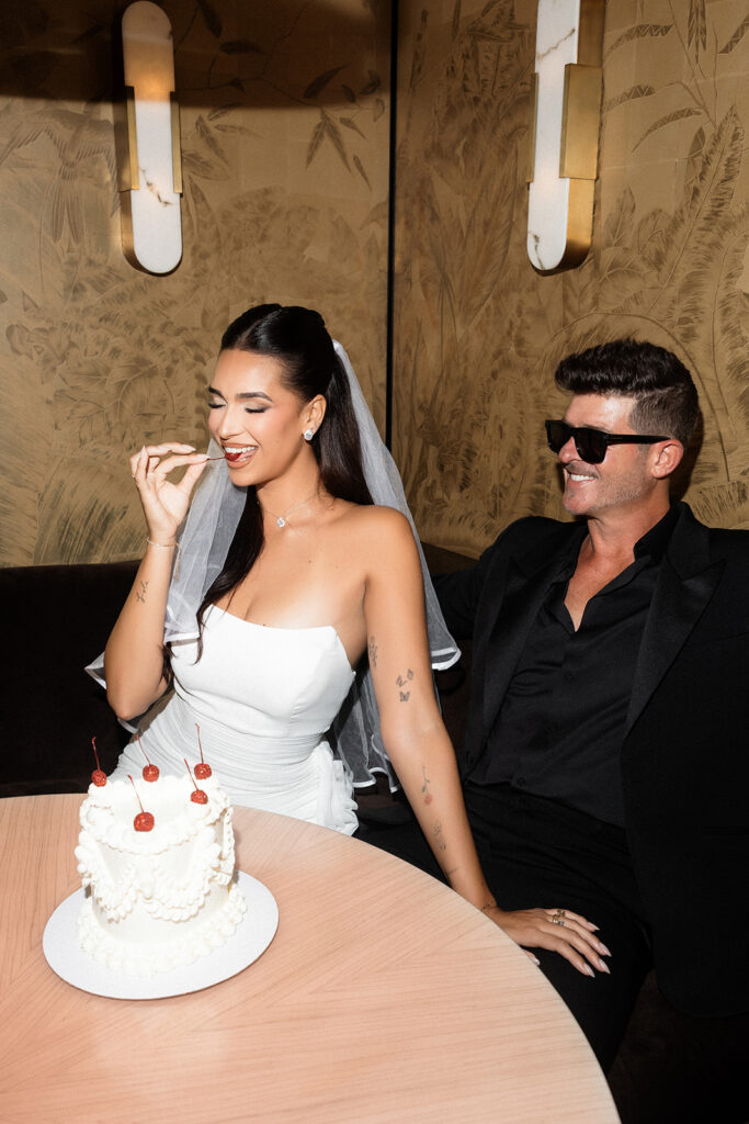 April eating a cherry off of her Las Vegas elopement cake made by Winston Marie Cakes