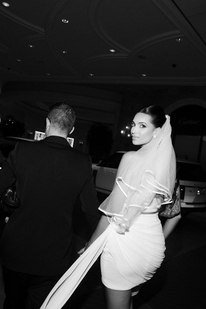 Black and white photo of the bride looking back at the camera during her Las Vegas elopement photoshoot