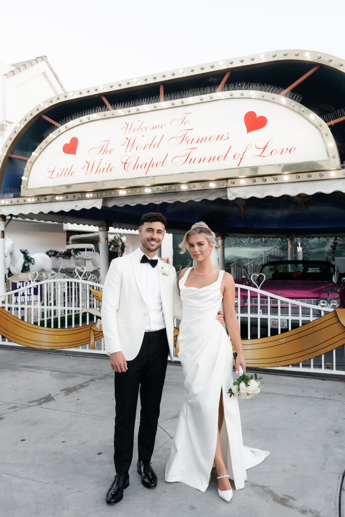 Bride and groom posing outside of The Tunnel of Love at a Little White Chapel for their classy elopement in Vegas.