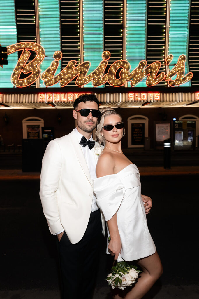 Flash photo of a bride and groom posing in front of Binion's on Fremont Street in Las Vegas.