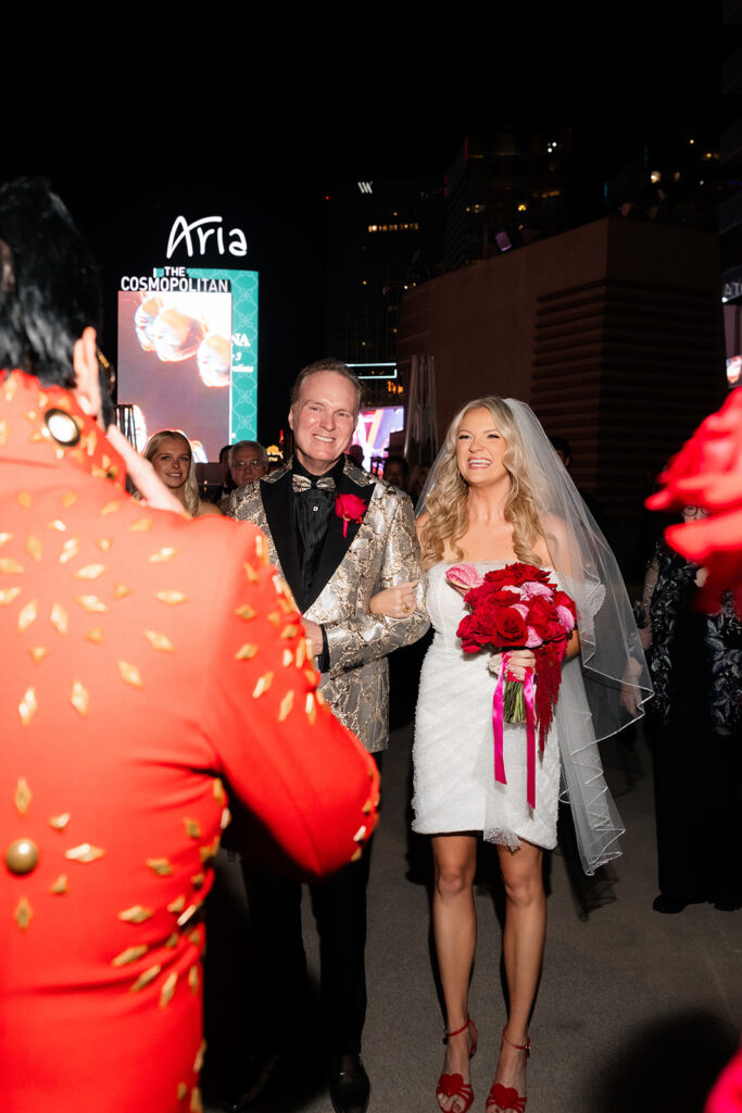 Bride walking down the aisle with her father during her Boulevard Pool Deck ceremony at The Cosmopolitan in Las Vegas.
