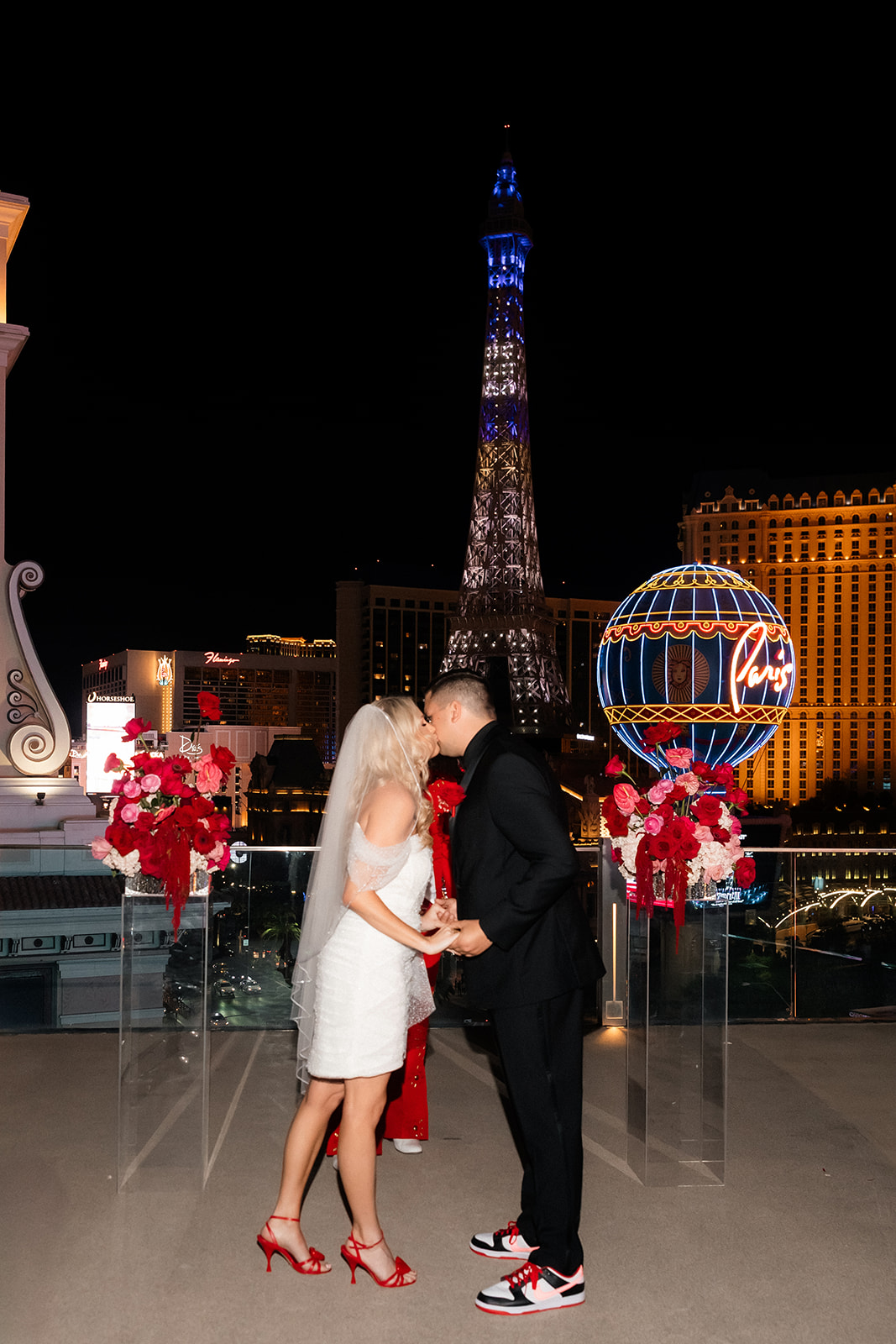 Bride and groom sharing their first kiss during the Boulevard Pool Deck ceremony at The Cosmopolitan in Las Vegas.