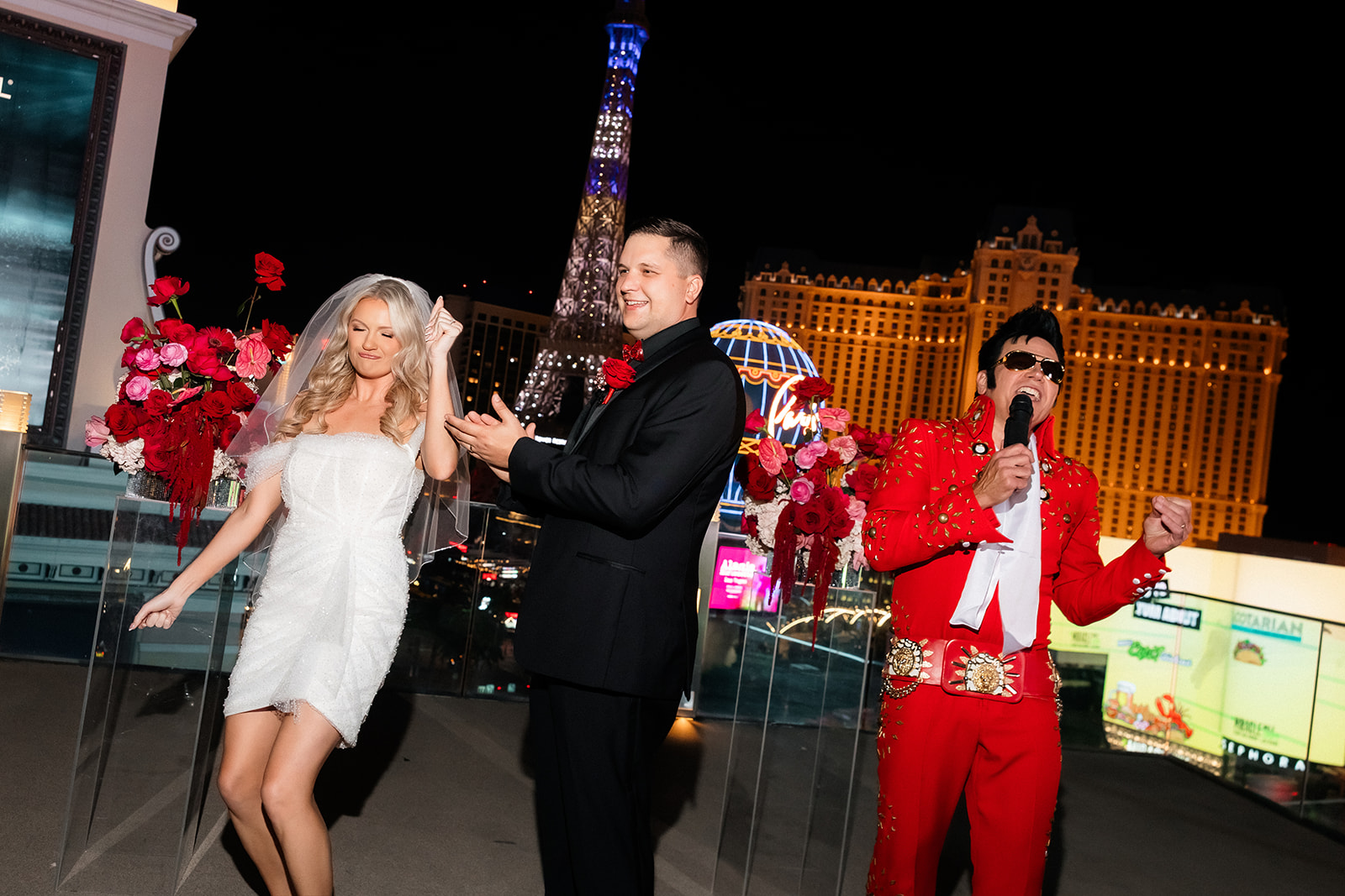 Bride and groom dancing with an Elvis impersonator during their Boulevard Pool Deck ceremony at The Cosmopolitan in Las Vegas.