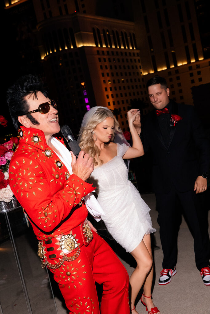 Elvis impersonator singing while the bride dances during the Boulevard Pool Deck ceremony at The Cosmopolitan in Las Vegas.