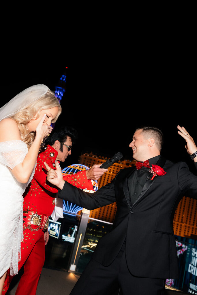 Bride and groom dancing together with an Elvis impersonator during their Boulevard Pool Deck ceremony in Las Vegas.