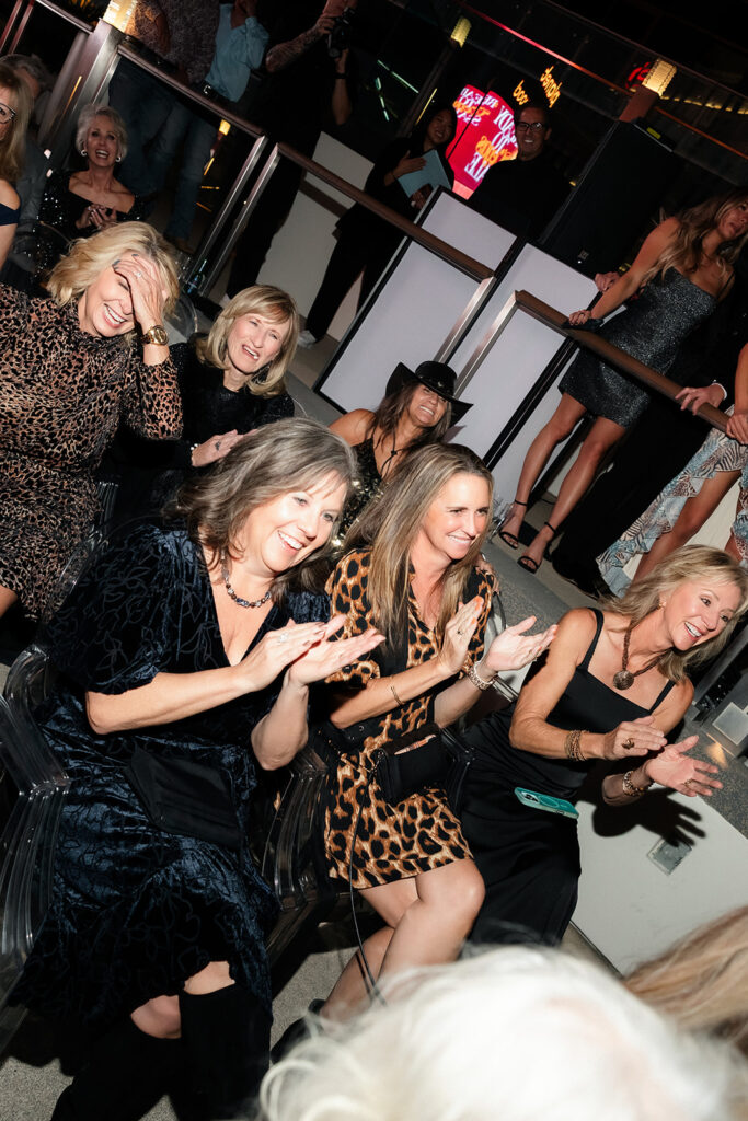 Guests laughing and applauding during the ceremony.