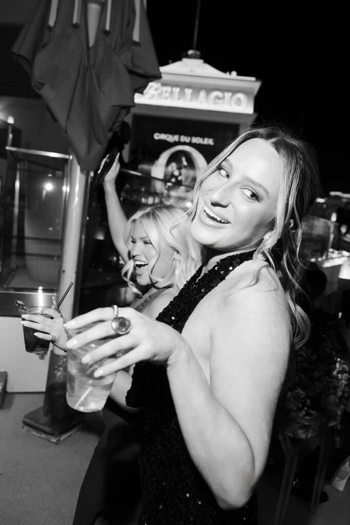 Guests dancing and celebrating during a rooftop Cosmopolitan wedding reception overlooking the Las Vegas Strip.