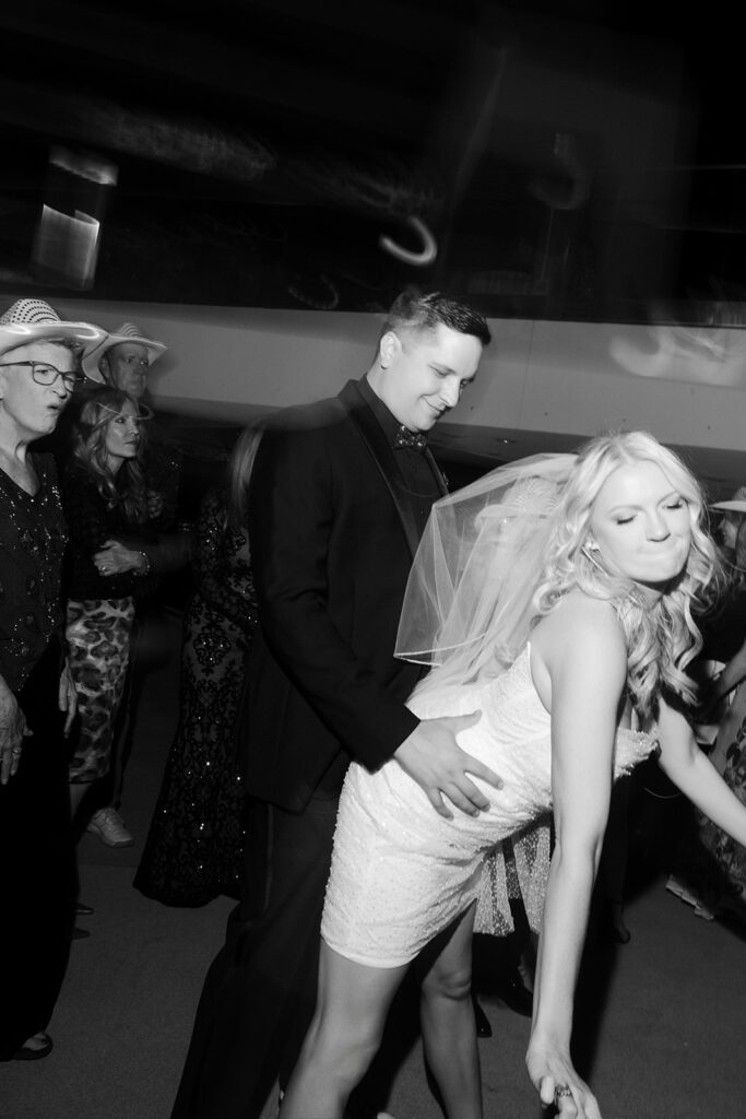 Black and white photo of a bride and groom dancing during their reception.