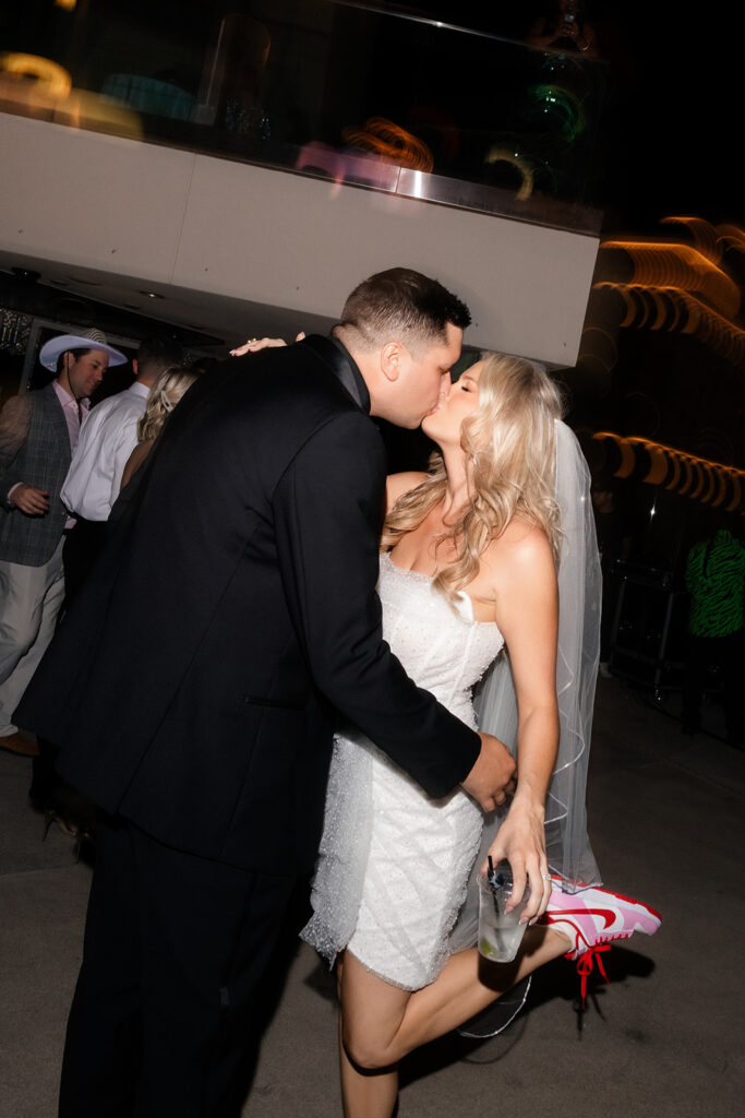 Bride and groom kissing during their rooftop reception.