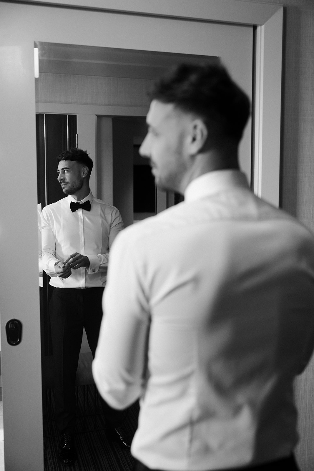 Black and white photo of a groom getting ready for his classy elopement in Vegas. 