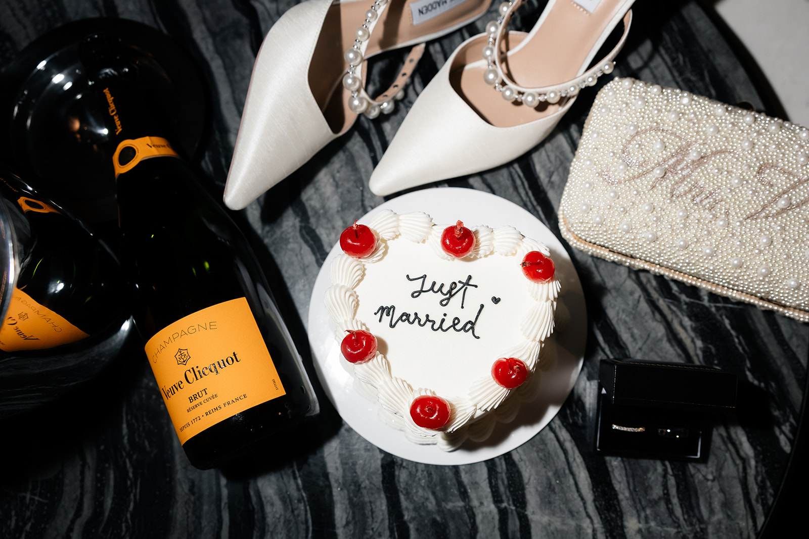 Las Vegas elopement detail shot of cake, champagne. the brides heels and purse. 