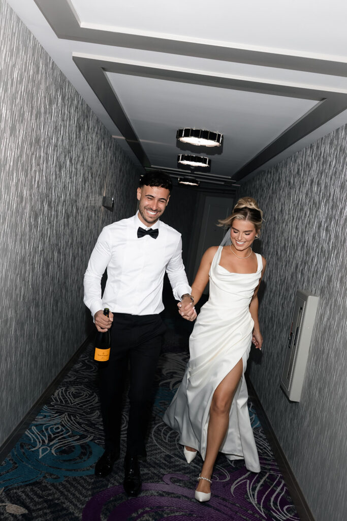 Bride and groom walking down the hallway at The Cosmopolitan for their classy elopement in Vegas. 