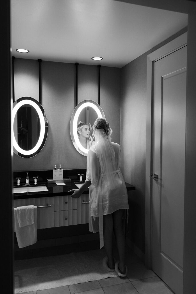 Black and white photo of a bride posing in the mirror at The Cosmopolitan in Las Vegas.