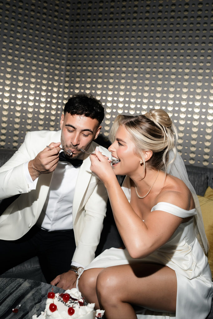 Bride and groom eating cake during their classy elopement in Vegas at the Cosmo.