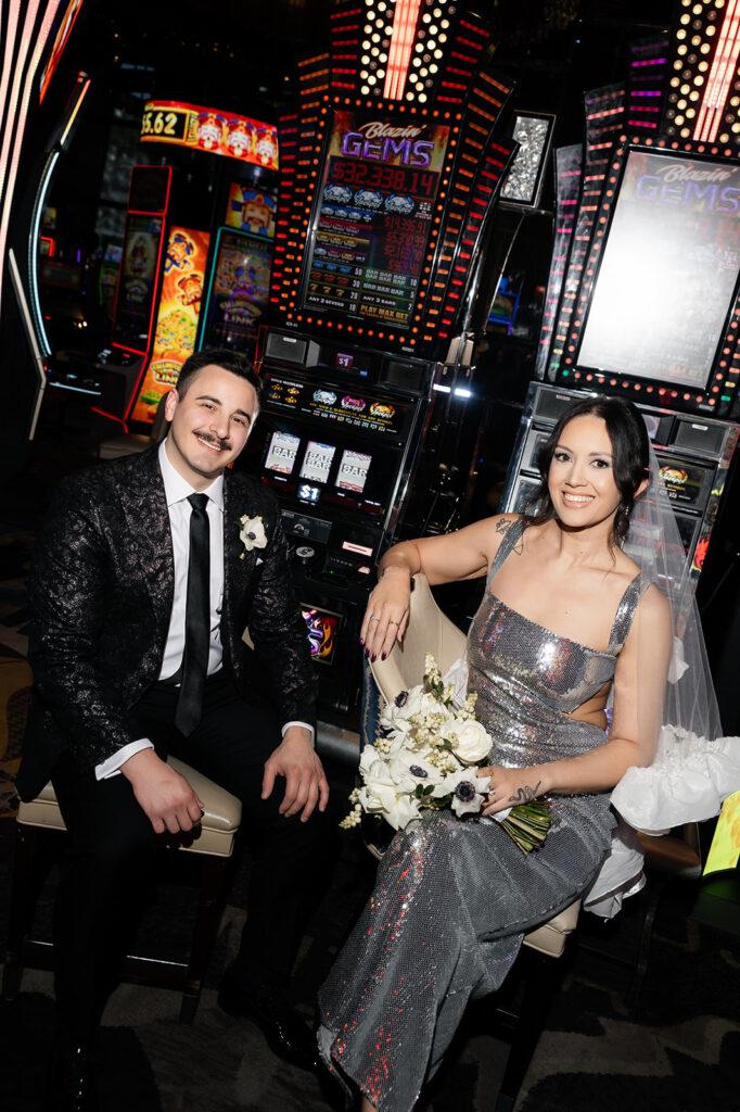 Bride and groom smiling together in casino portraits.