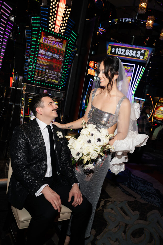 Bride and groom smiling together in casino portraits.