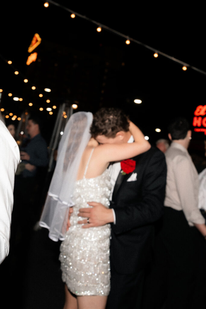 Newlyweds sharing a close dance on the rooftop at Commonwealth during their Las Vegas wedding reception.