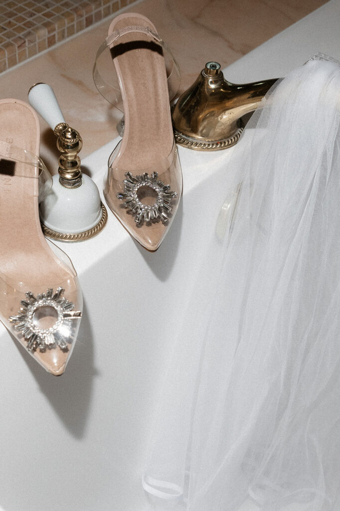 Close-up of bridal heels and veil styled on a bathroom counter at the Golden Nugget in Las Vegas.