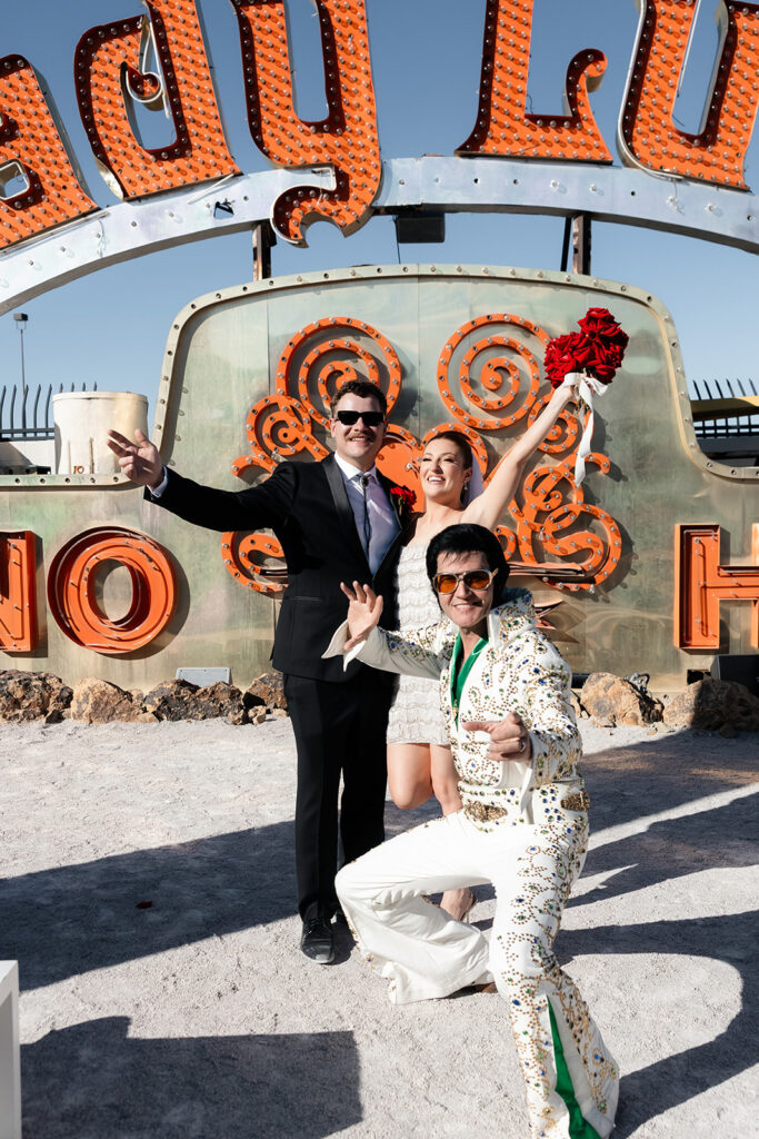 Couple celebrating their Las Vegas wedding with the Elvis officiant at the Neon Museum.