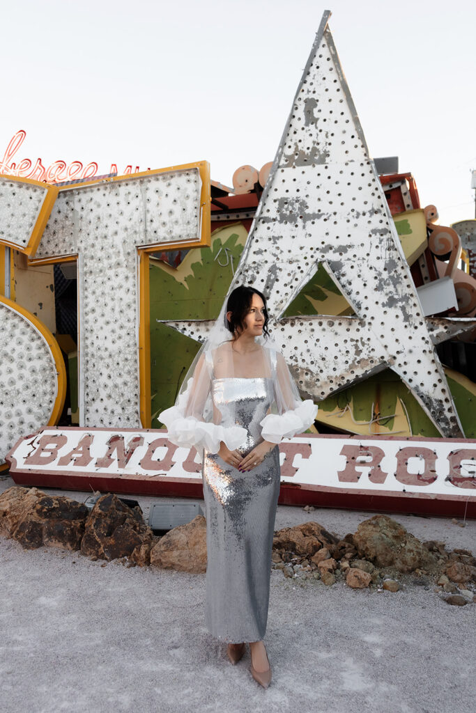 Bride posing in front of neon signs at the Neon Museum in Las Vegas.