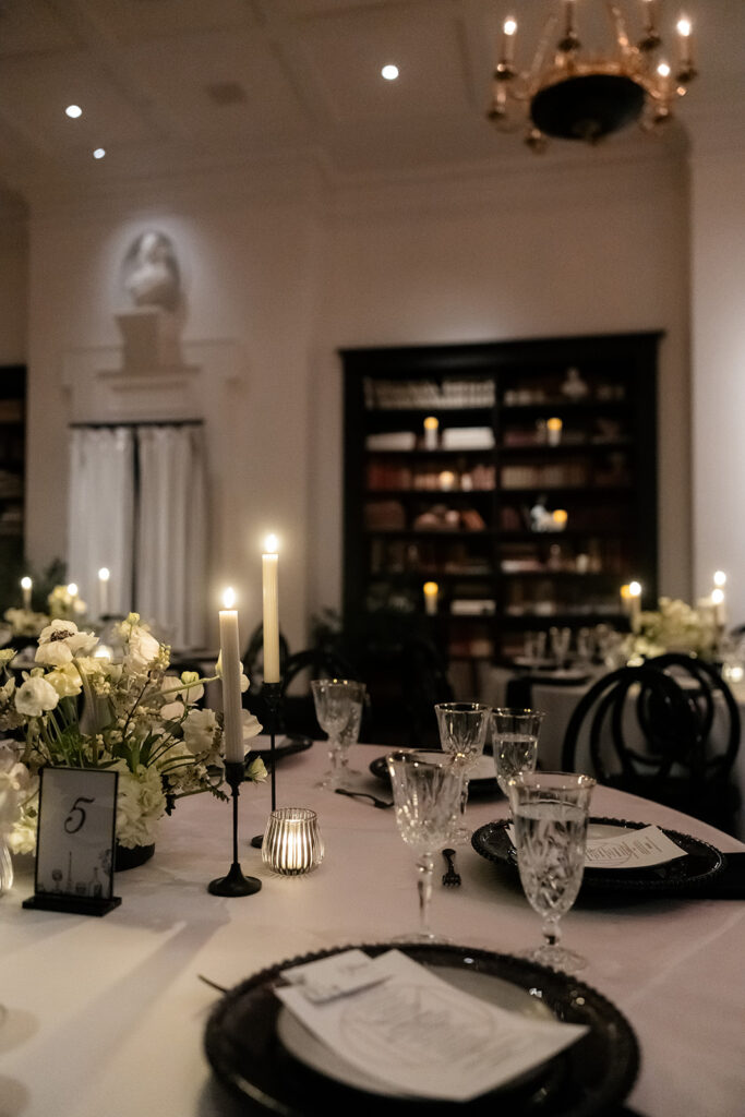 Elegant dinner table styling with candles and glassware at NoMad Library in Las Vegas.