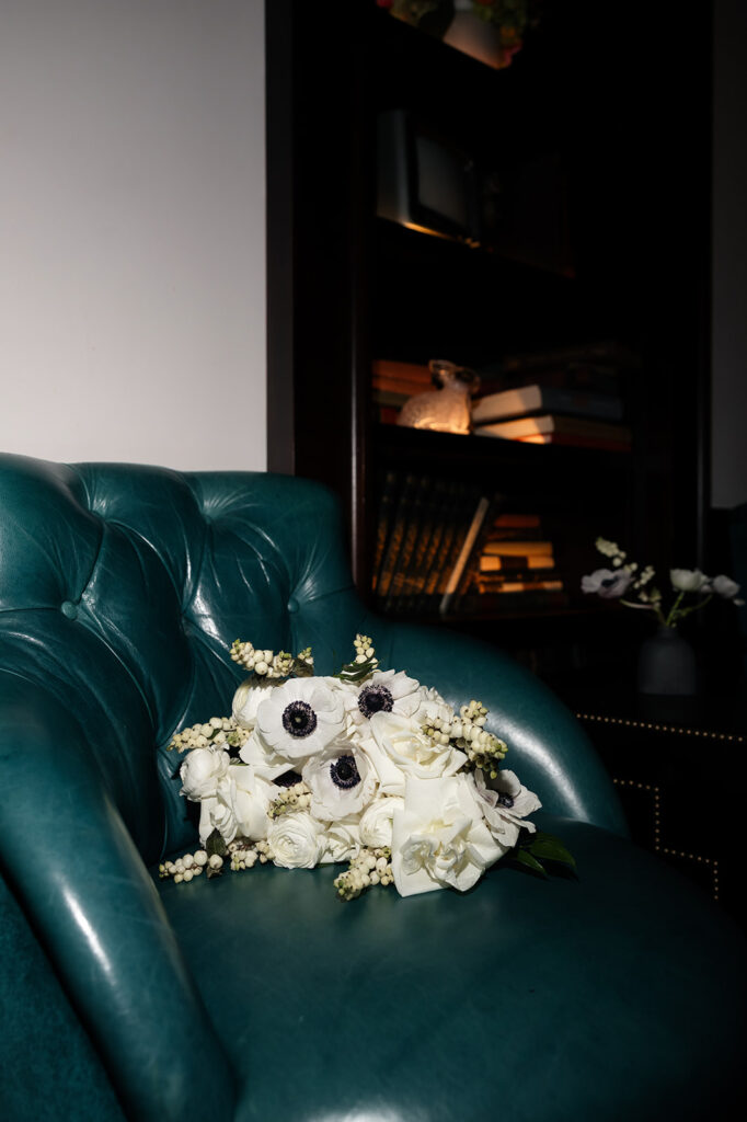 Moody lounge seating and florals inside the NoMad Library Parlour Room at Park MGM.