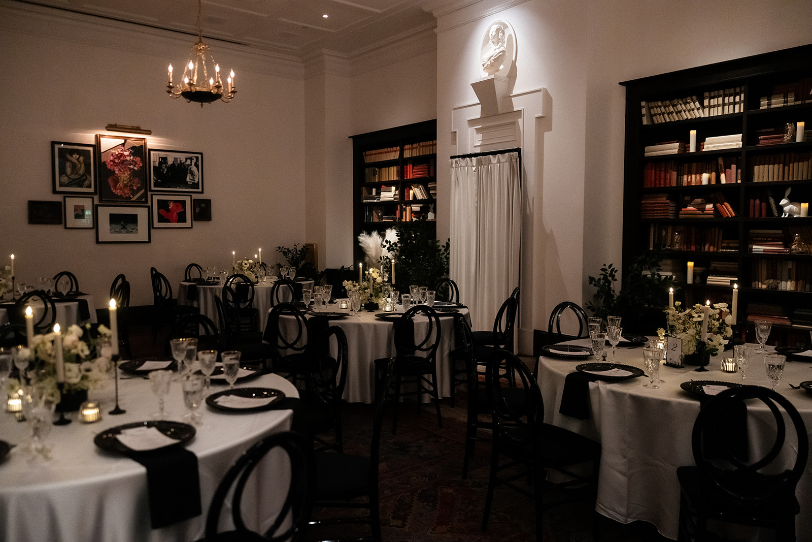 Candlelit reception tables surrounded by bookshelves inside the NoMad Library at Park MGM.