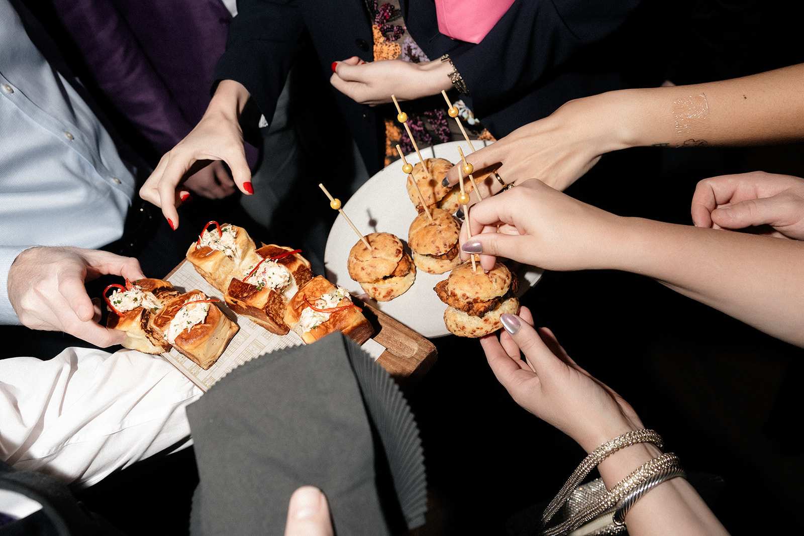 Guests enjoying late-night bites during a NoMad Library Las Vegas micro wedding reception in the Parlour Room at Park MGM.
