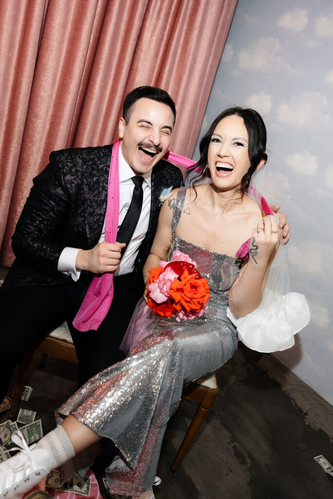 Couple laughing after their Surely The Showgirl performance during their Las Vegas micro wedding at Sure Thing Chapel.